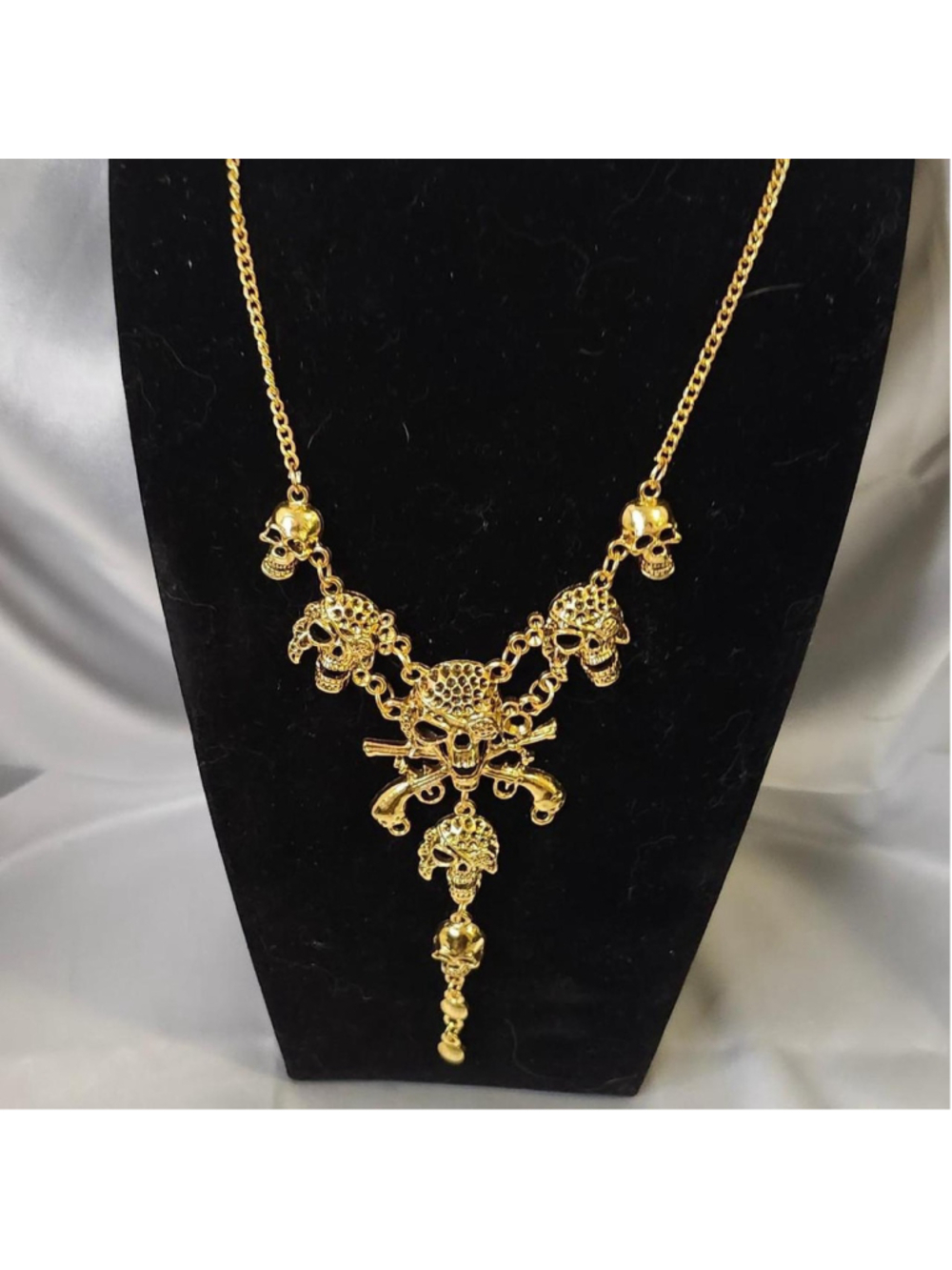 Gold skull necklace with crossbones
